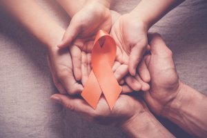Family holds an orange ribbon for ADHD awareness