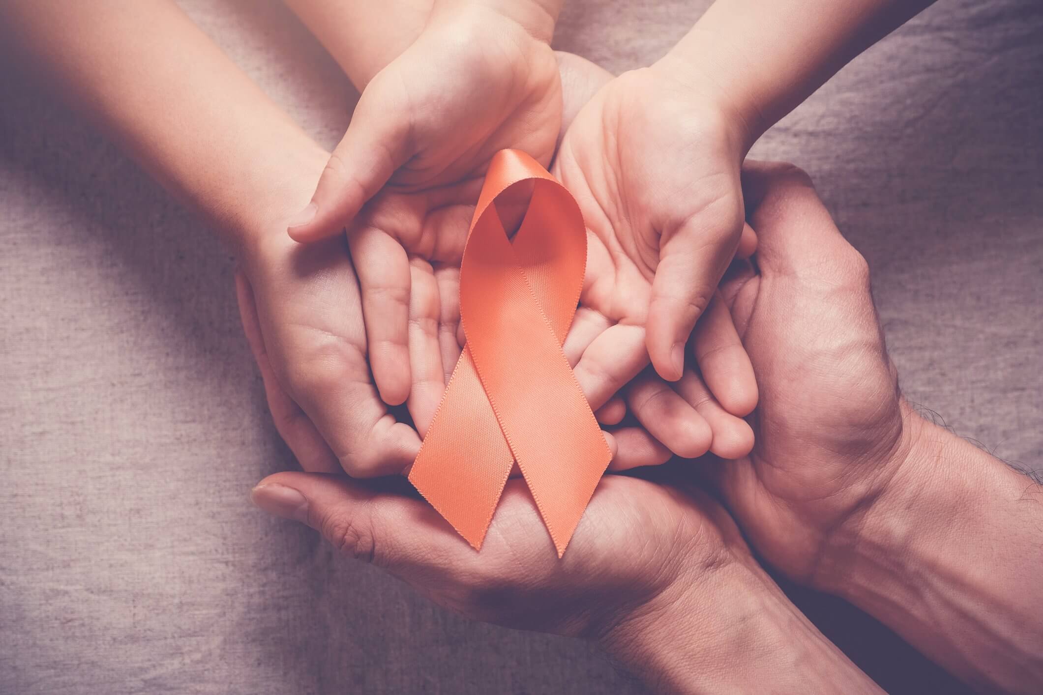 Family holds an orange ribbon for ADHD awareness