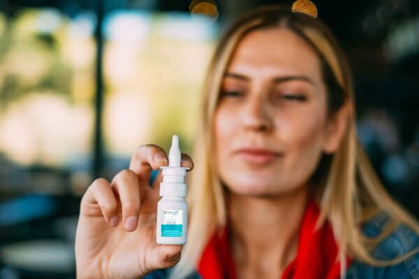 Woman-holding-bottle-of-anti-viral-nasal-spray