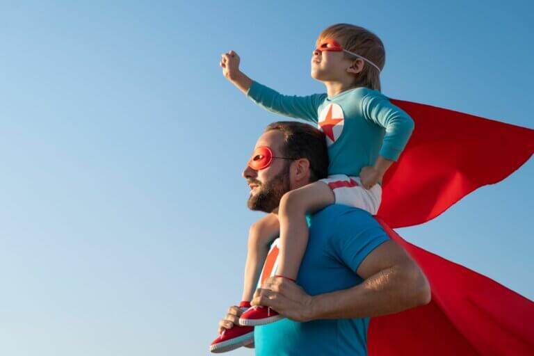 Boy-on-father's-shoulders-wearing-super-hero-capes