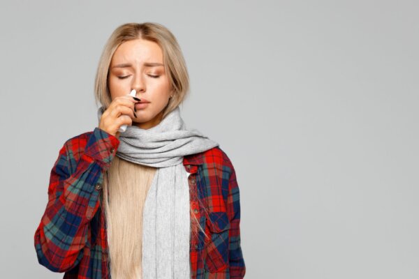 Woman using antiviral nasal spray