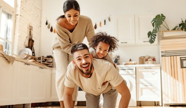 Happy multiracial family playing in kitchen